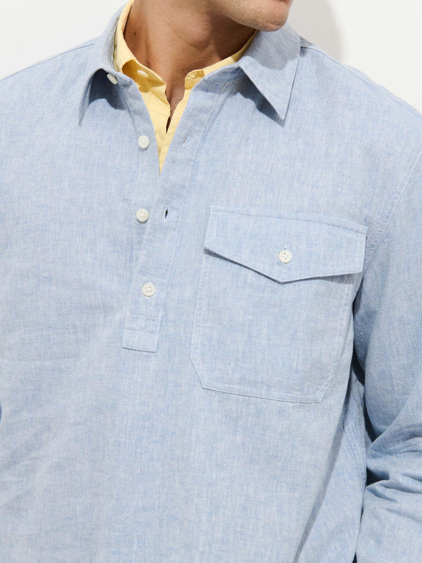 Alex Mill Carter long sleeve popover shirt in light blue cotton linen with chest pocket and white buttons.
