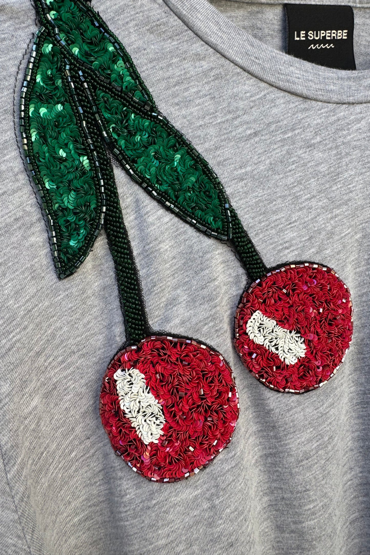 Le Superbe heather grey t-shirt featuring sequined cherry embellishment with red fruit and green leaves