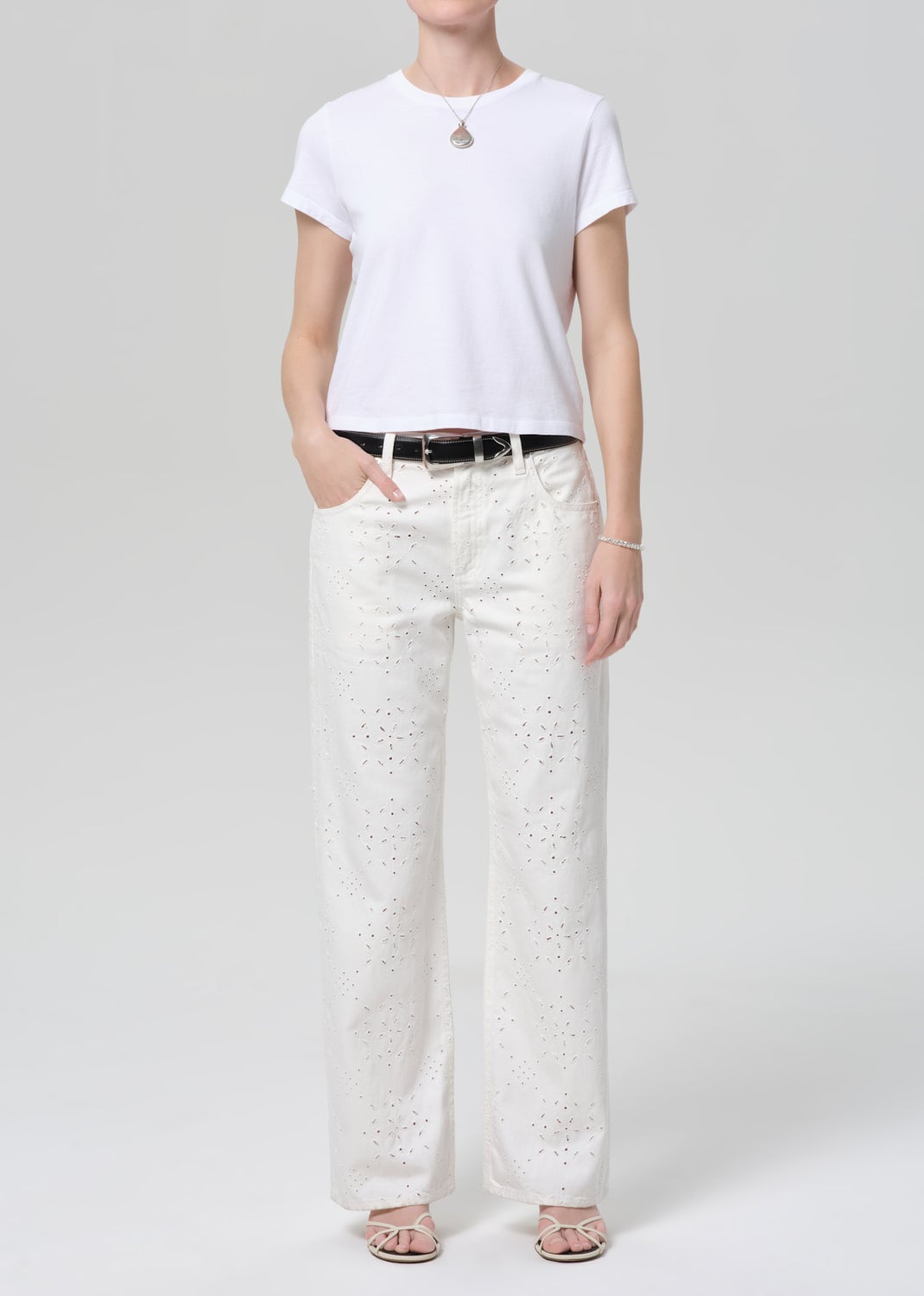 Model wearing Citizens of Humanity Lindz Easy Straight jeans in white with eyelet detail