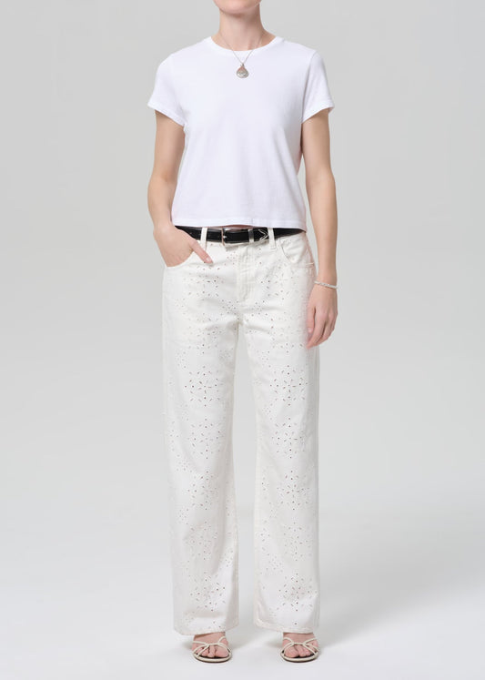 Model wearing Citizens of Humanity Lindz Easy Straight jeans in white with eyelet detail