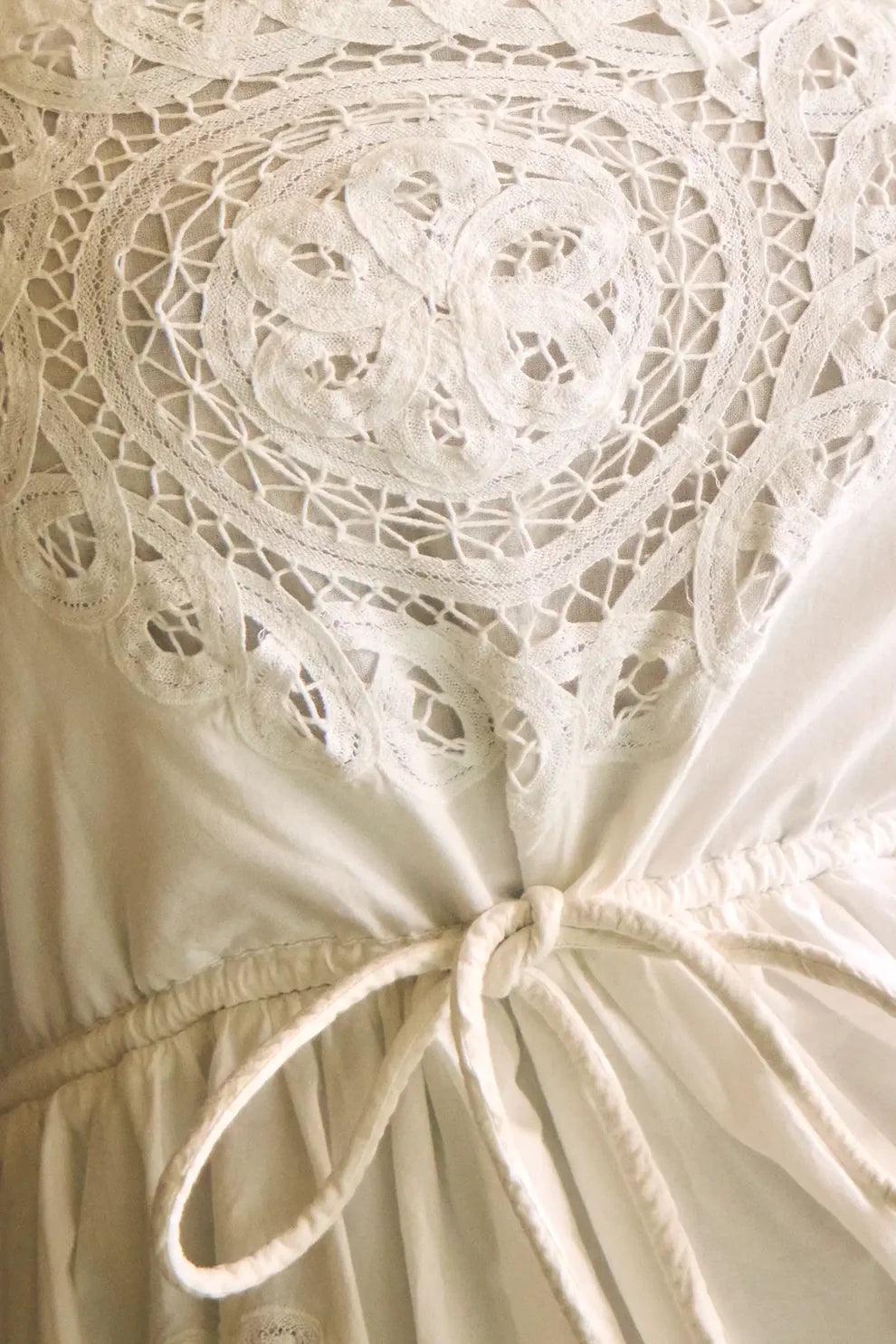 White Hunter Bell Cosette dress featuring intricate lace cutout detailing on bodice with drawstring waist tie.