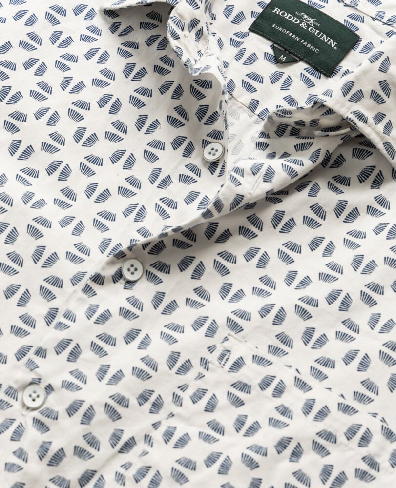 Rodd & Gunn Crown Hill short sleeve shirt featuring white fabric with blue fan-shaped geometric pattern and collar detail.