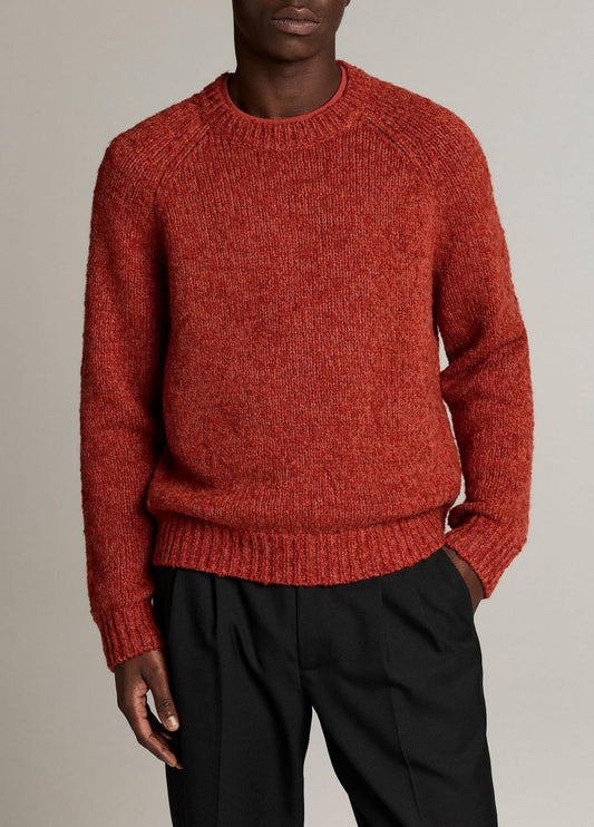Male model wearing Vince rust-red bouclé raglan sleeve crew neck sweater with black trousers
