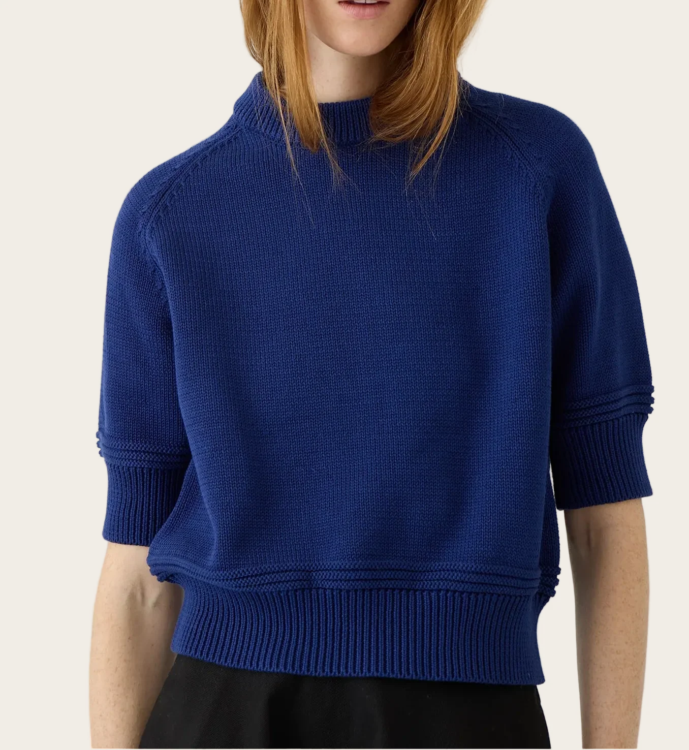 Model wearing Demylee Daria short-sleeve cotton knit sweater in Baltic Blue with mock neck