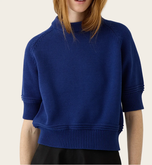 Model wearing Demylee Daria short-sleeve cotton knit sweater in Baltic Blue with mock neck