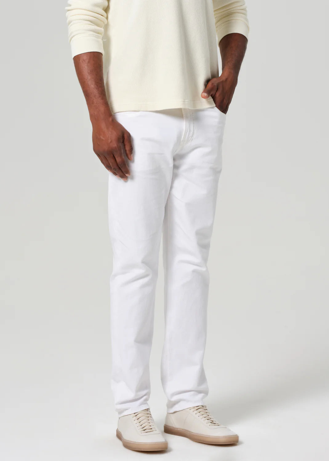 Citizens of Humanity Elijah white stretch linen pants shown on model with cream sweater and beige sneakers