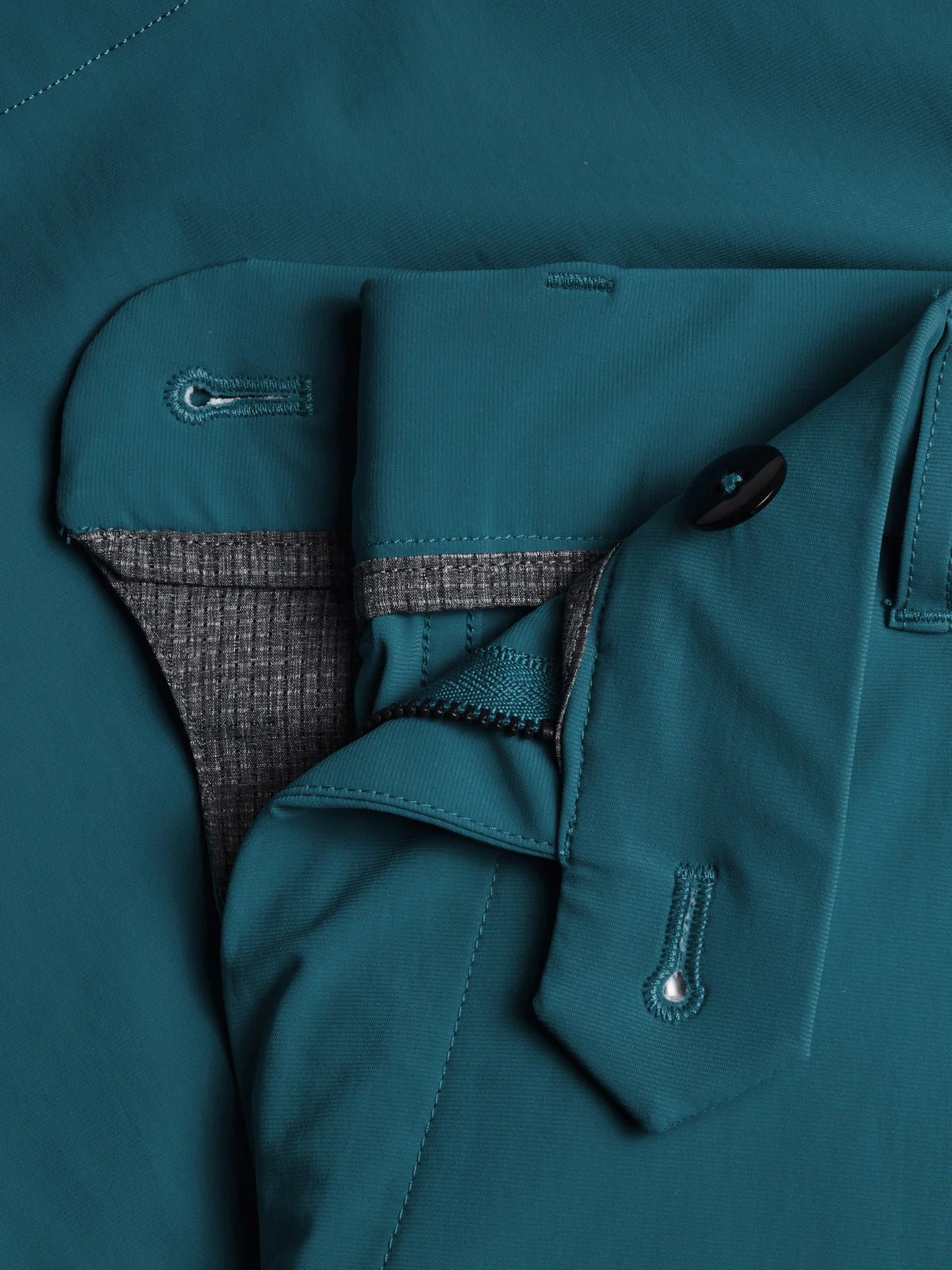 Close-up view of Greyson golf shorts showing zipper fly, waistband button, and interior fabric details.
