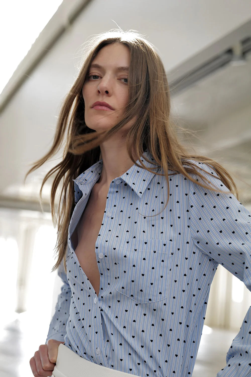 Woman wearing Le Superbe Prep Love BF Shirt with heart print and striped pattern in relaxed boyfriend style.