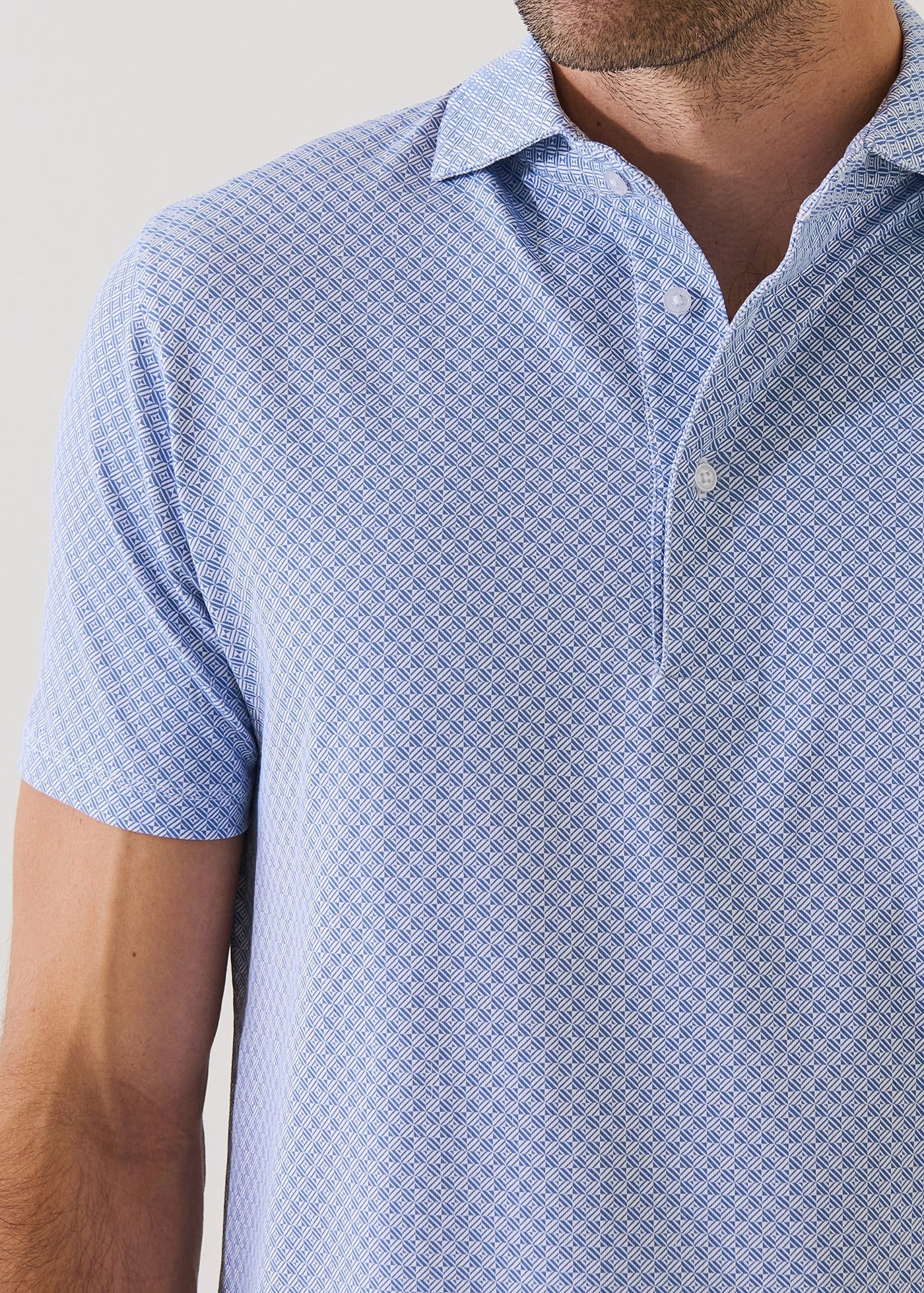 Patrick Assaraf short sleeve polo shirt featuring a geometric diamond print pattern in blue and white.