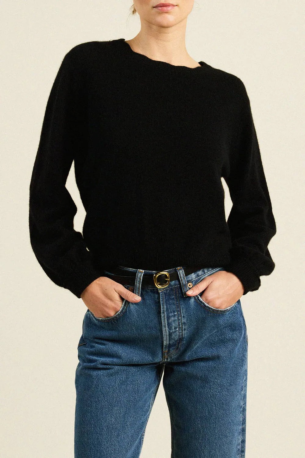 Trovata Kate black cropped crew-neck knit sweater with long sleeves, styled with blue jeans.