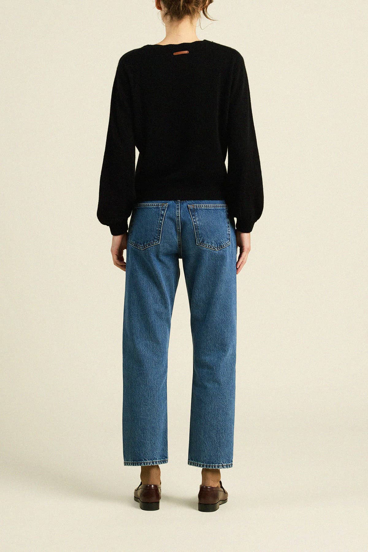 Trovata Kate black knit sweater with balloon sleeves, shown from the back on a model.