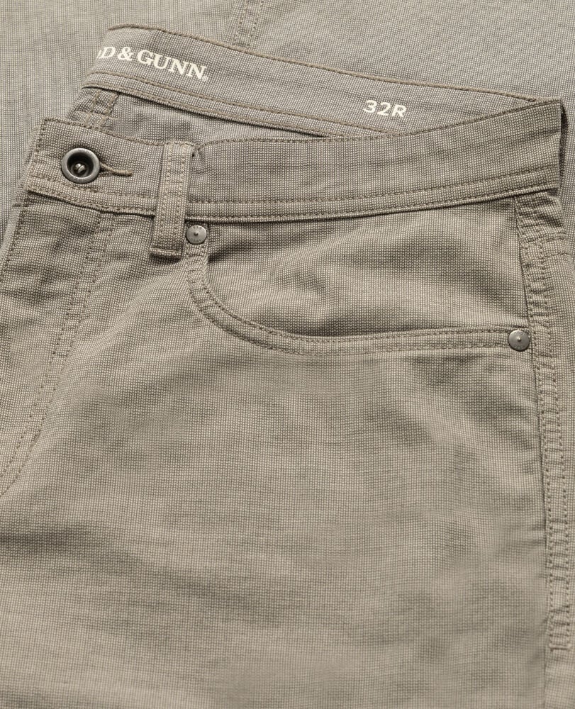 Rodd & Gunn men's five-pocket pants in neutral tone showing waistband, button closure, and front pocket detail.