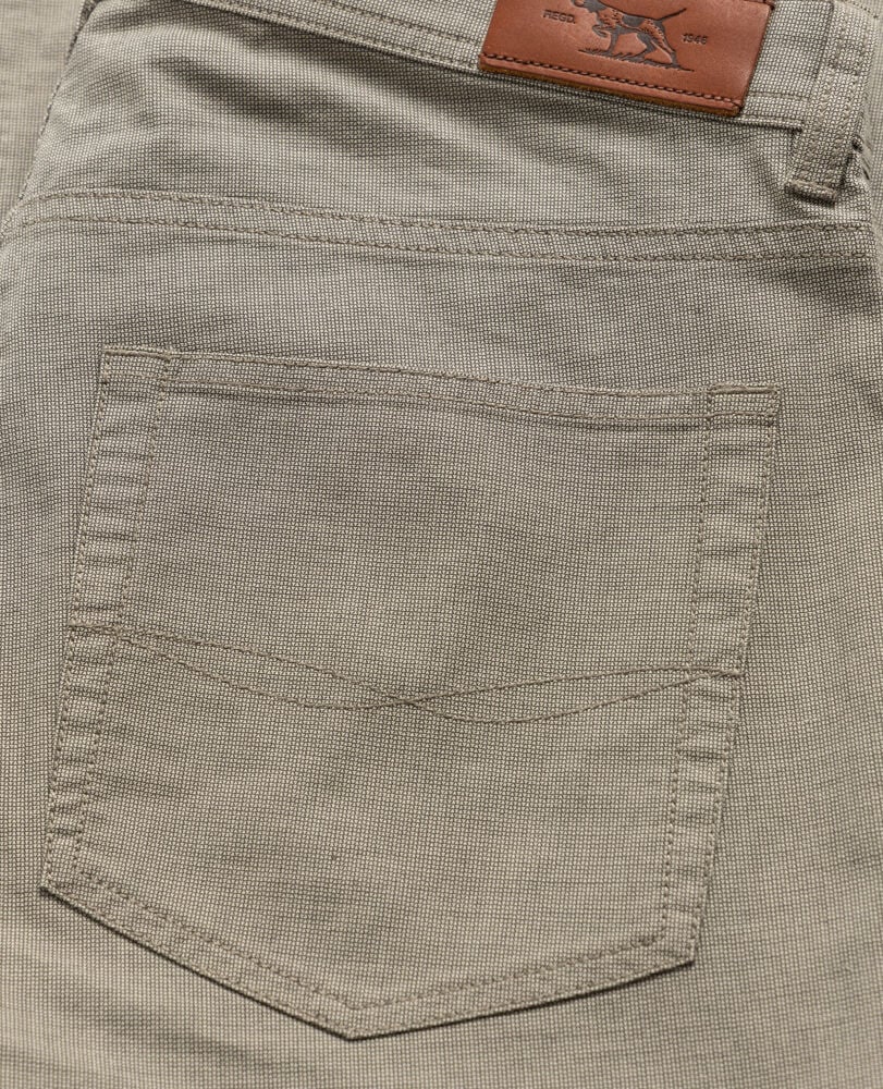 Rodd & Gunn men's five-pocket pants showing back pocket detail with leather brand patch and textured fabric construction.