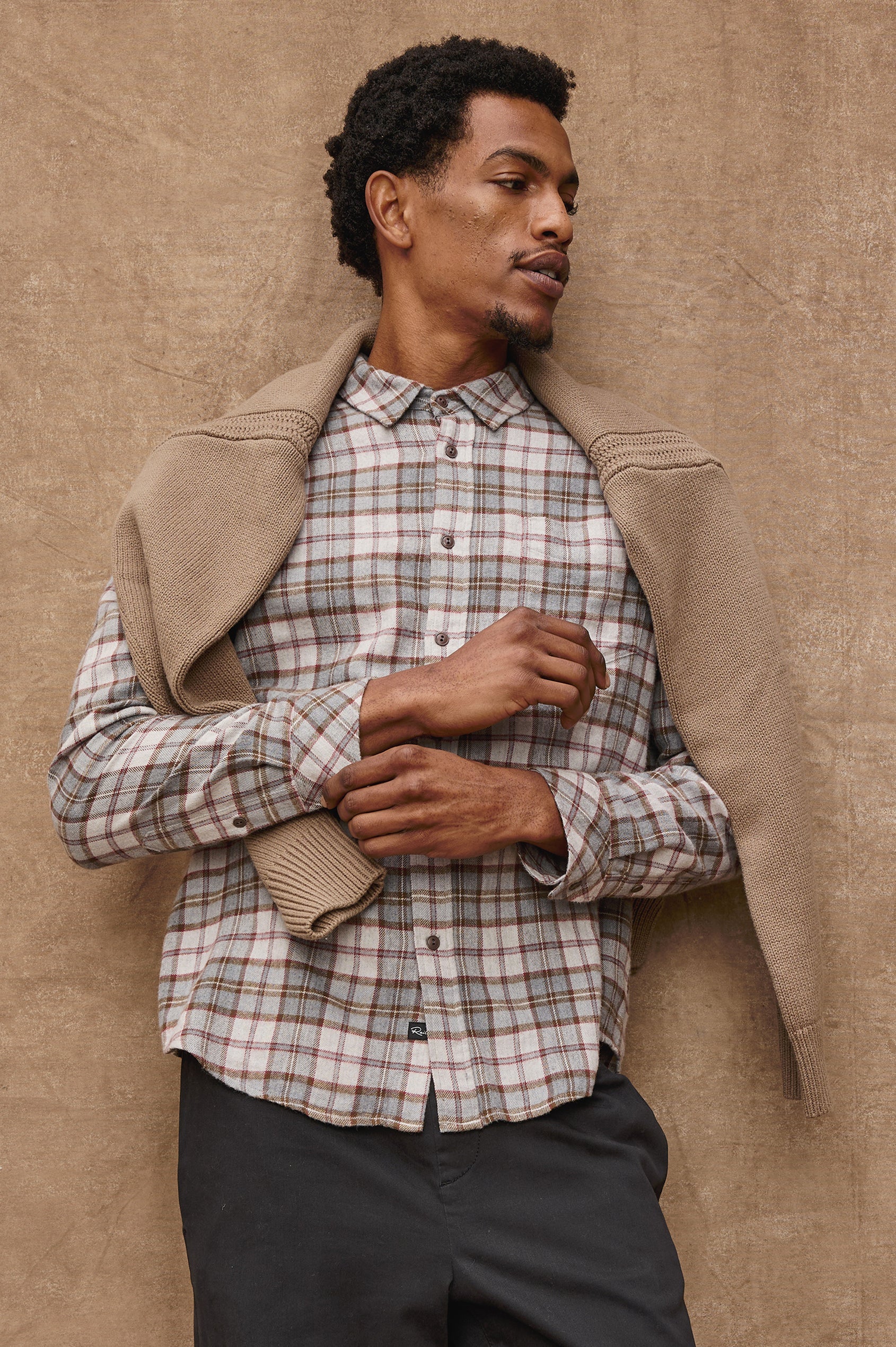 Man wearing Rails Lennox long sleeve plaid shirt in charcoal autumn melange with beige cardigan