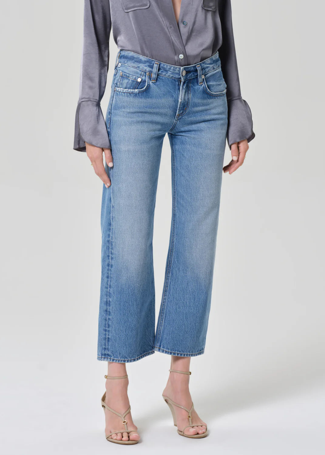 Citizens of Humanity Faye vintage straight jeans in medium wash denim with wide leg silhouette, worn with gray blouse and ...