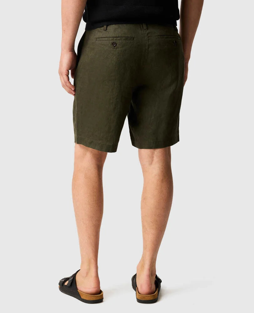 Rodd & Gunn Resort Linen Shorts in dark olive, shown from behind on model wearing black sandals.