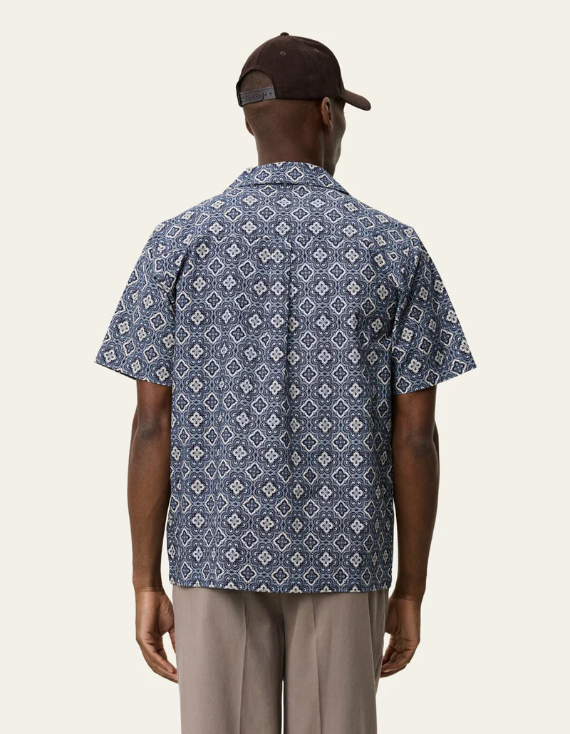 Les Deux short-sleeve shirt with geometric arabesque pattern, shown from behind on male model wearing black cap and beige ...