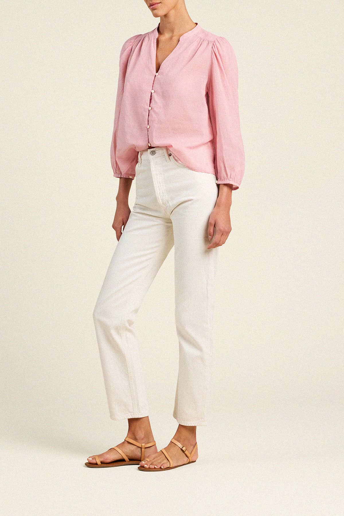 Trovata Maisey blouse in pink houndstooth pattern with puffed sleeves and button-front closure, styled with white jeans.