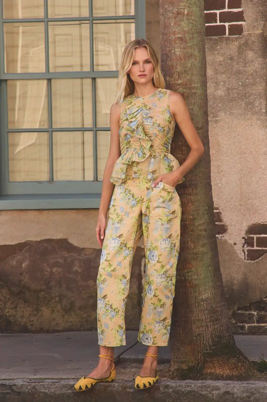 Hunter Bell Mallory floral print jumpsuit with ruched sleeveless top and wide-leg pants styled with yellow woven flats.