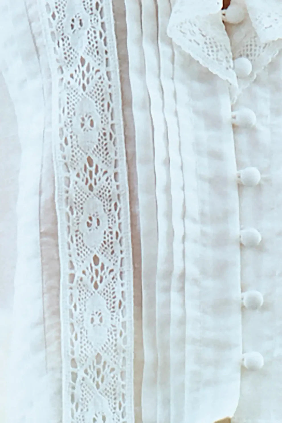 Hunter Bell Mare white lace top with intricate eyelet embroidery and button-front closure detail.