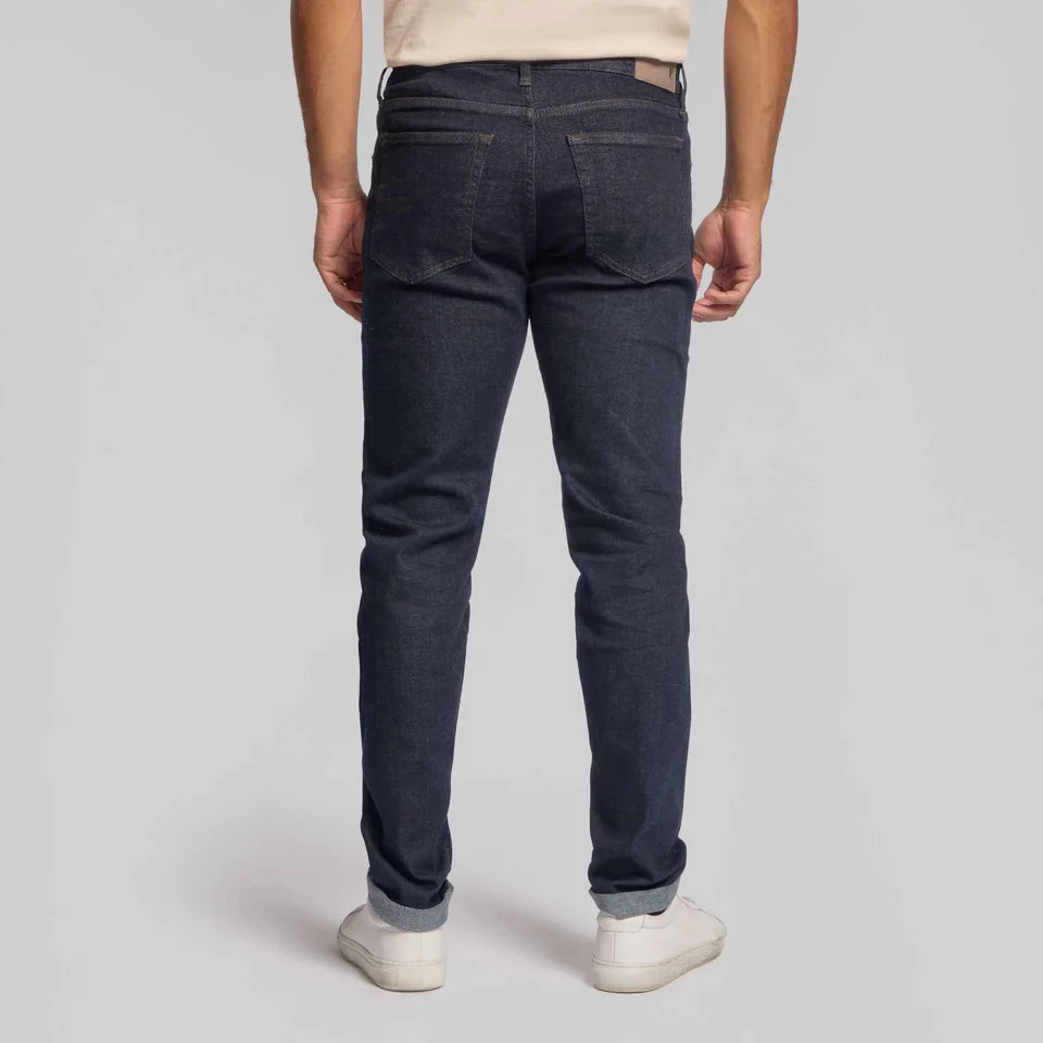 Rye 51 Candiani men's stretch selvedge denim jeans shown from behind with cuffed hems and white sneakers
