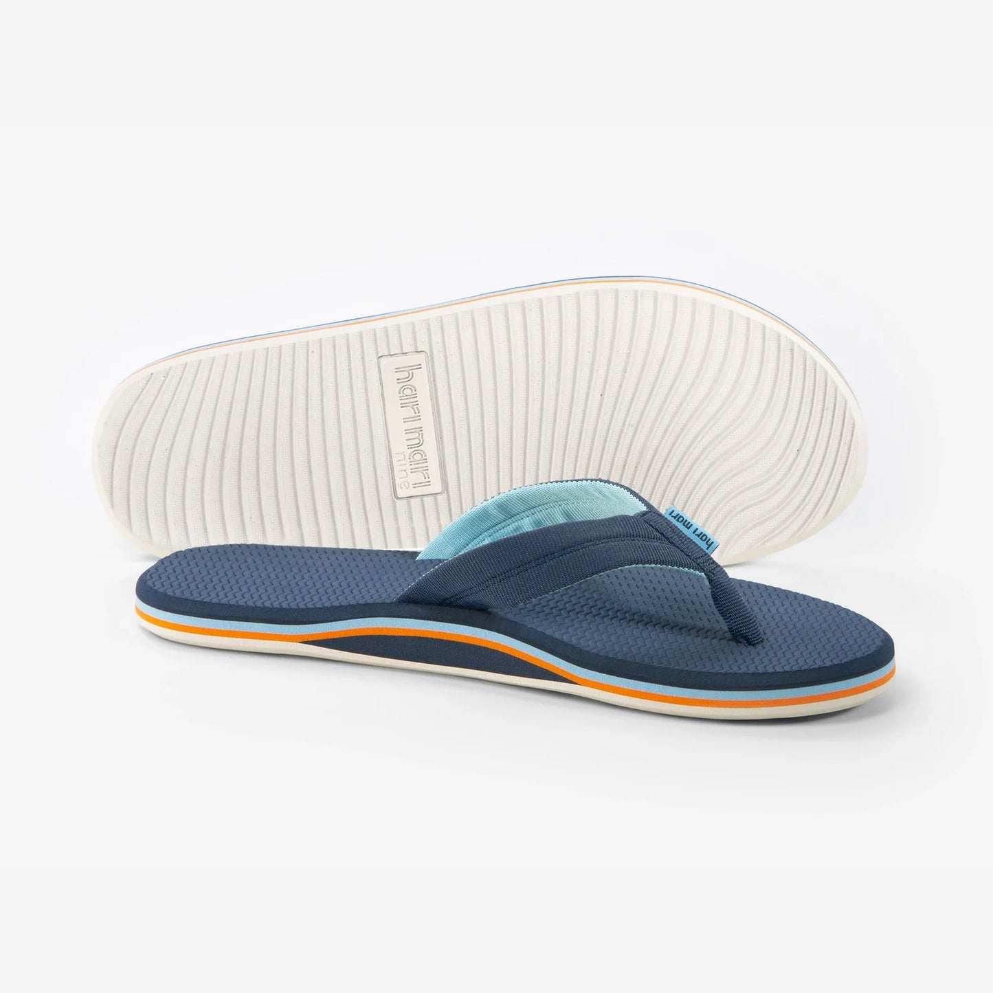 Hari Mari Dunes navy blue flip-flops with textured footbed and white sole, shown from side and bottom view.