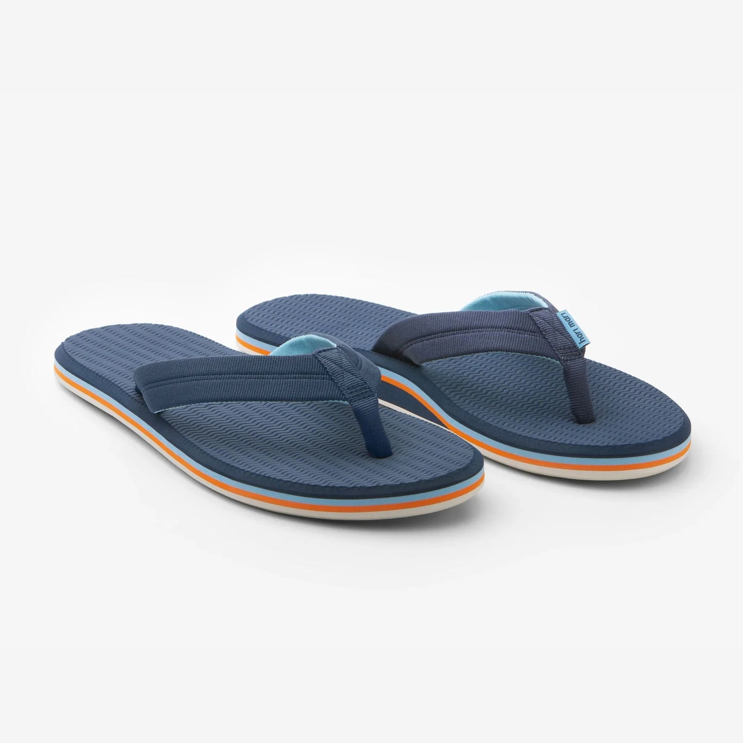 Navy blue Hari Mari Dunes flip-flops with textured footbed and orange accent stripe on white background.