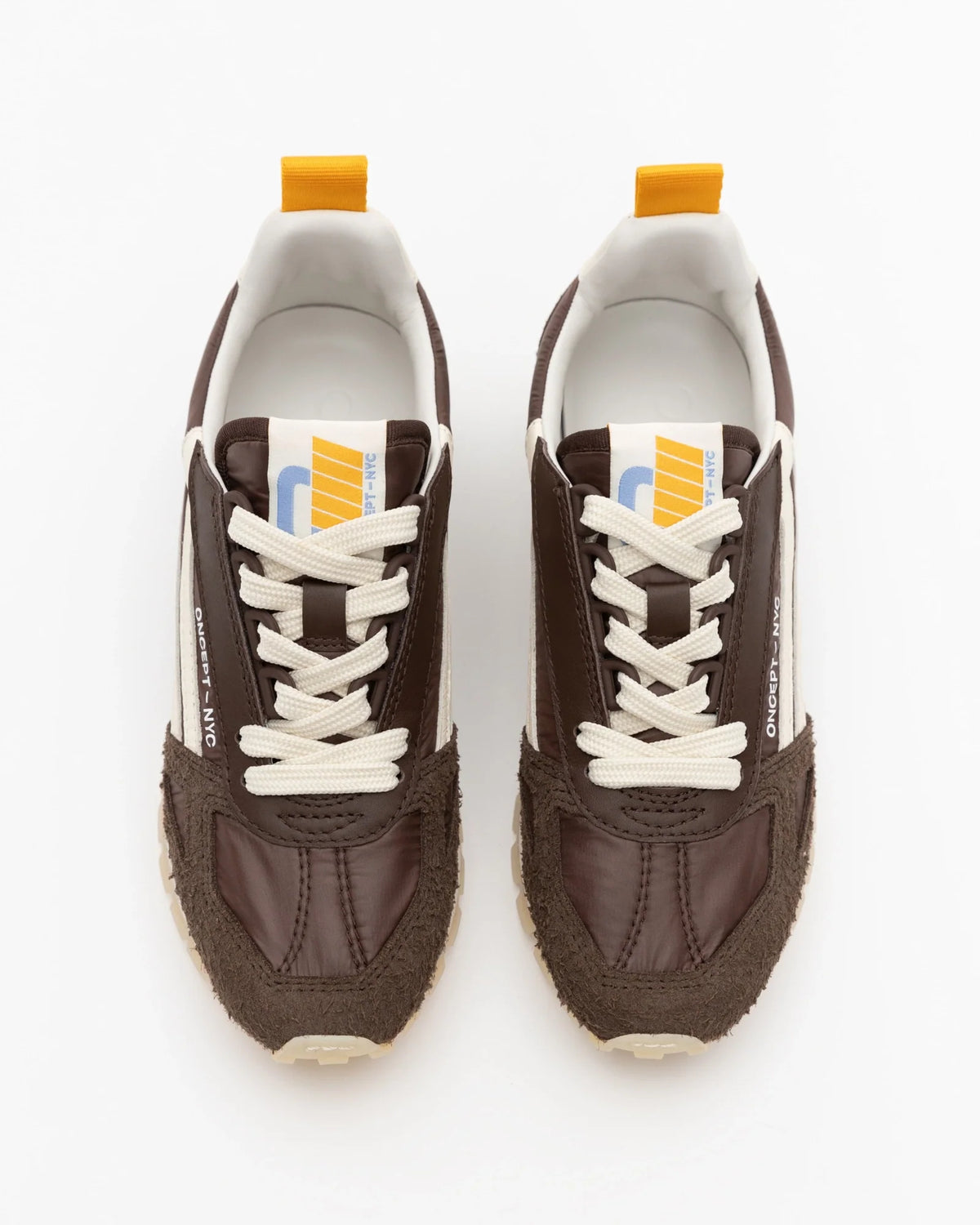Oncept Toronto men's sneakers in espresso brown with cream laces and yellow heel tab, top view