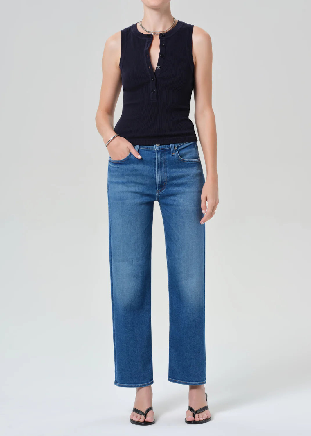 Citizens of Humanity Palma straight-leg jeans in blue denim wash, styled with black sleeveless top and sandals.