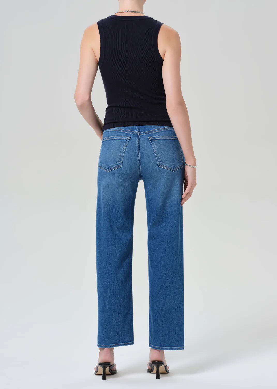 Citizens of Humanity Palma straight leg jeans in medium blue wash, shown from behind with black tank top
