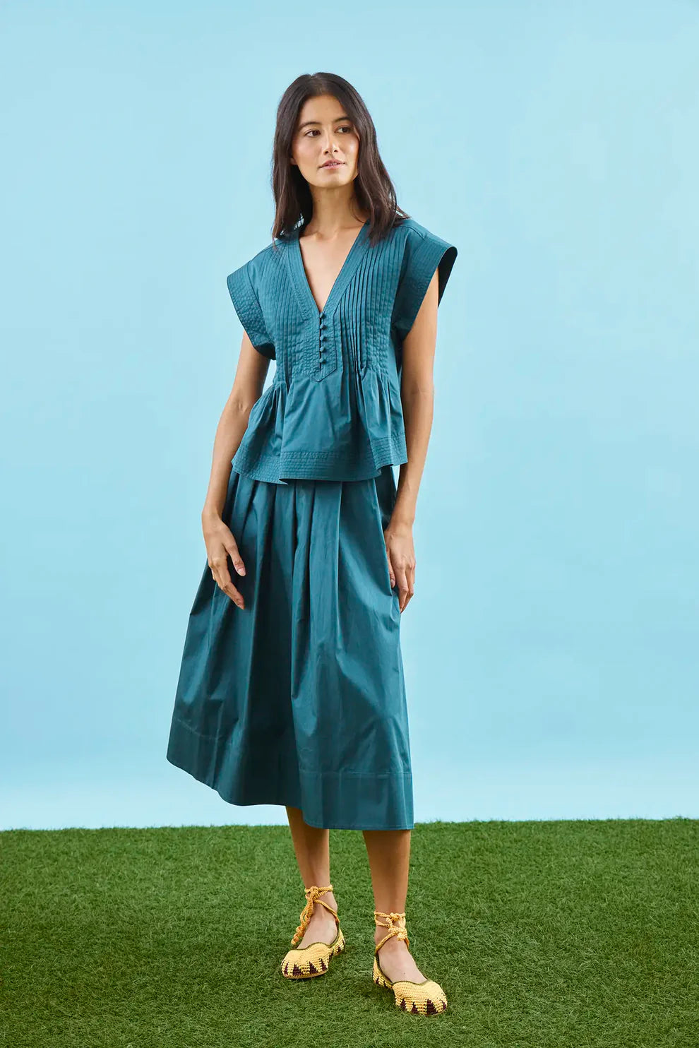 Hunter Bell Maison petrol green midi skirt with pleated waistband and A-line silhouette on model.