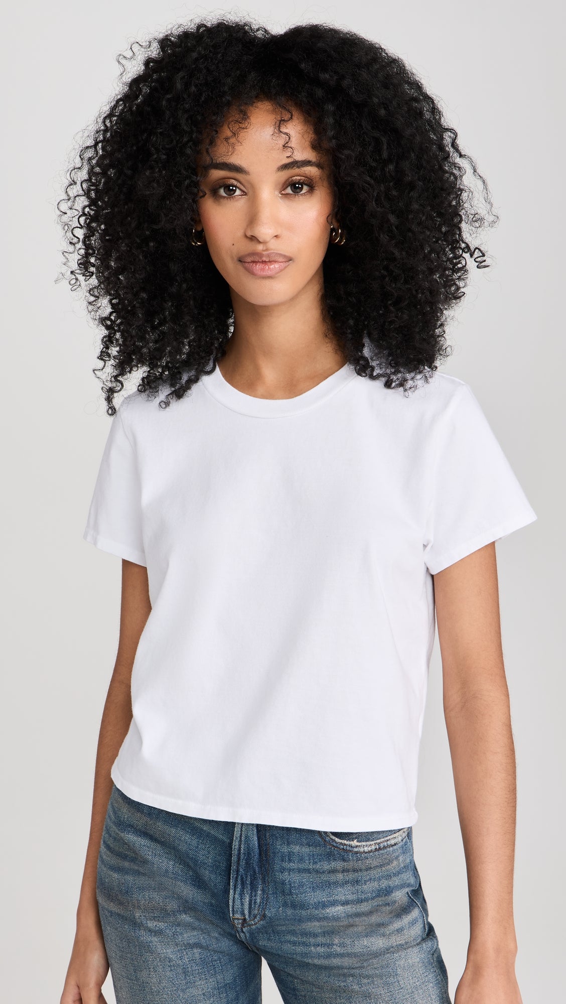 Woman wearing white crew neck short sleeve t-shirt with jeans