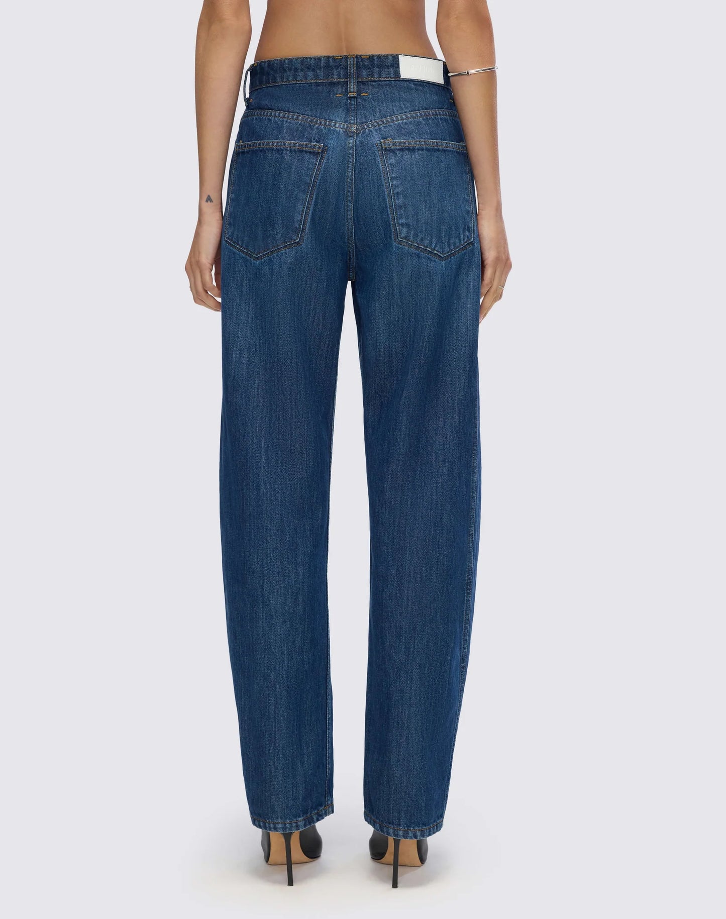Re/Done high-waisted wide-leg jeans shown from behind, featuring classic denim construction with back pockets and straight...