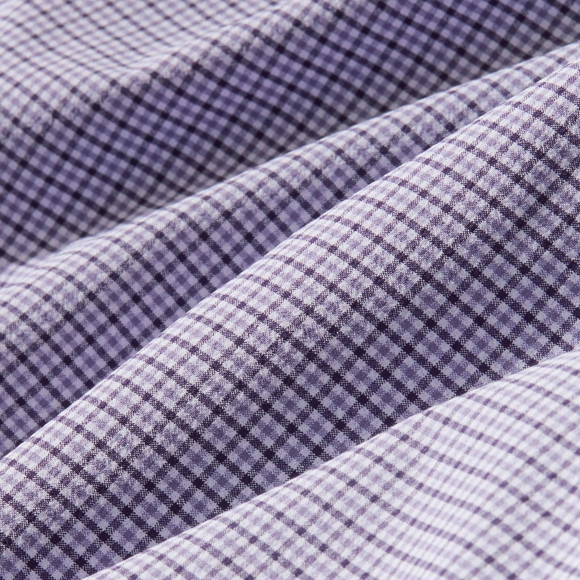 Mizzen + Main Leeward long sleeve dress shirt featuring purple and white gingham plaid pattern with folded fabric detail.