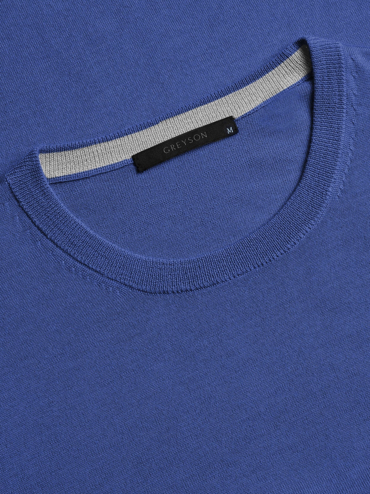Greyson blue crewneck sweater with ribbed neckline and black brand label showing size M