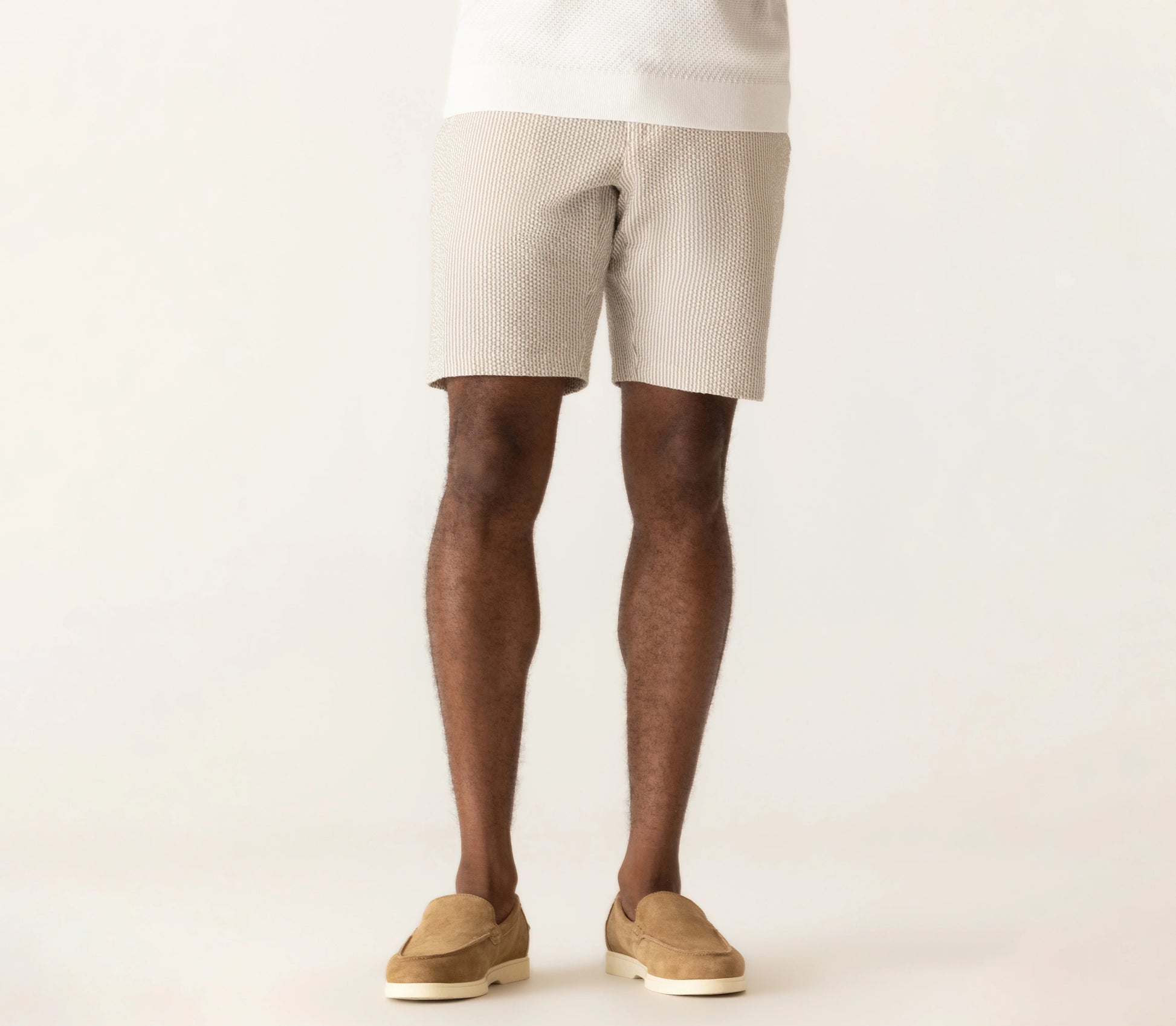 Deke Oasis Bermuda shorts in textured seersucker fabric, worn with suede loafers in a neutral tone.