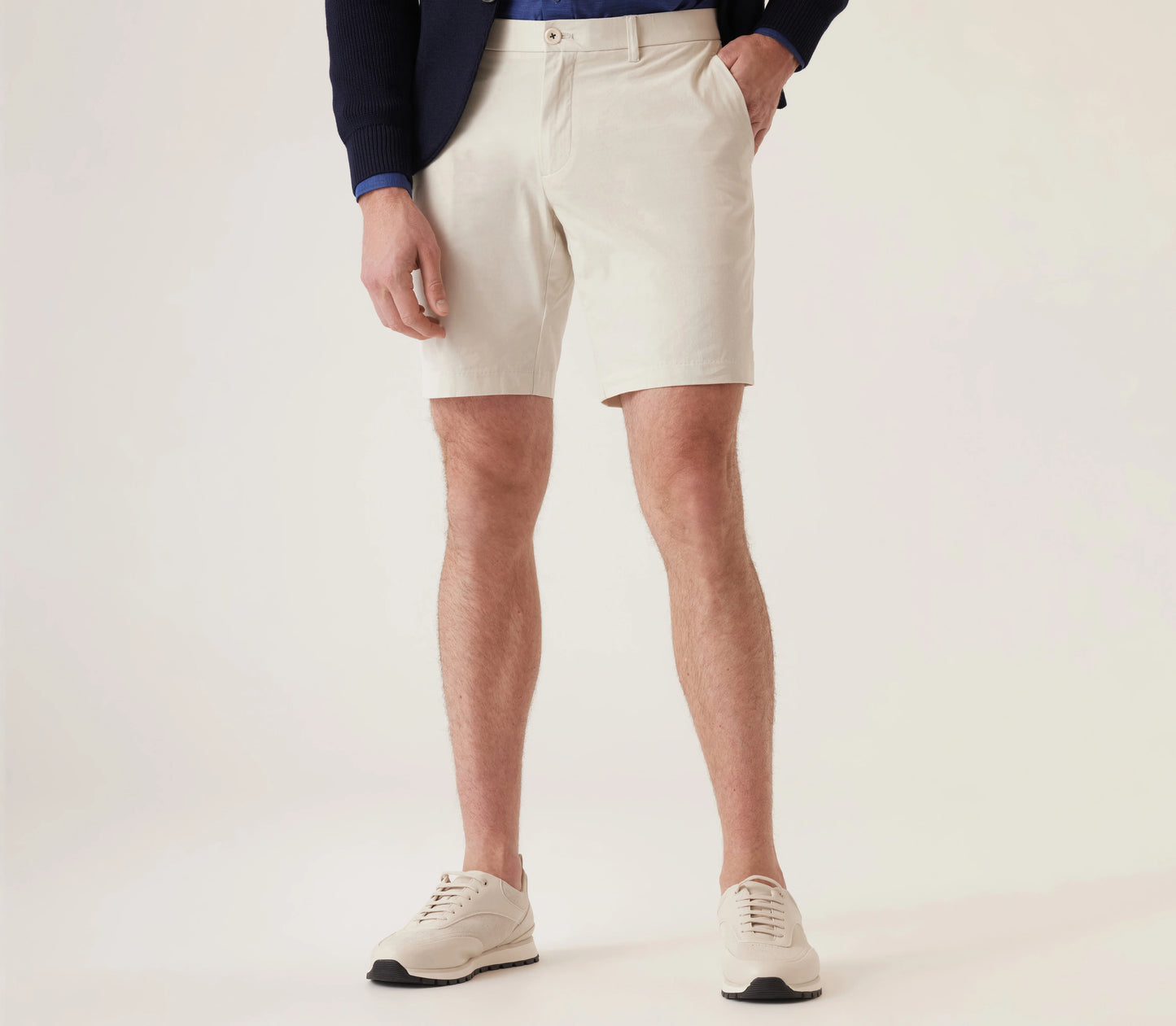 Man wearing light-colored Deke Galaxy Bermuda shorts in Ultra 4X Stretch Twill with navy blazer and sneakers