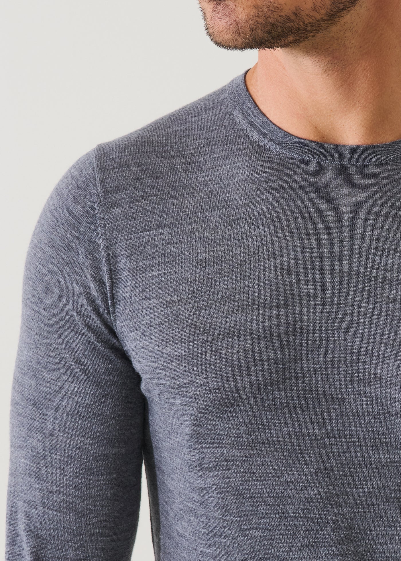 Man wearing Patrick Assaraf fine merino wool crew neck sweater in heathered grey, showing torso and neckline detail.