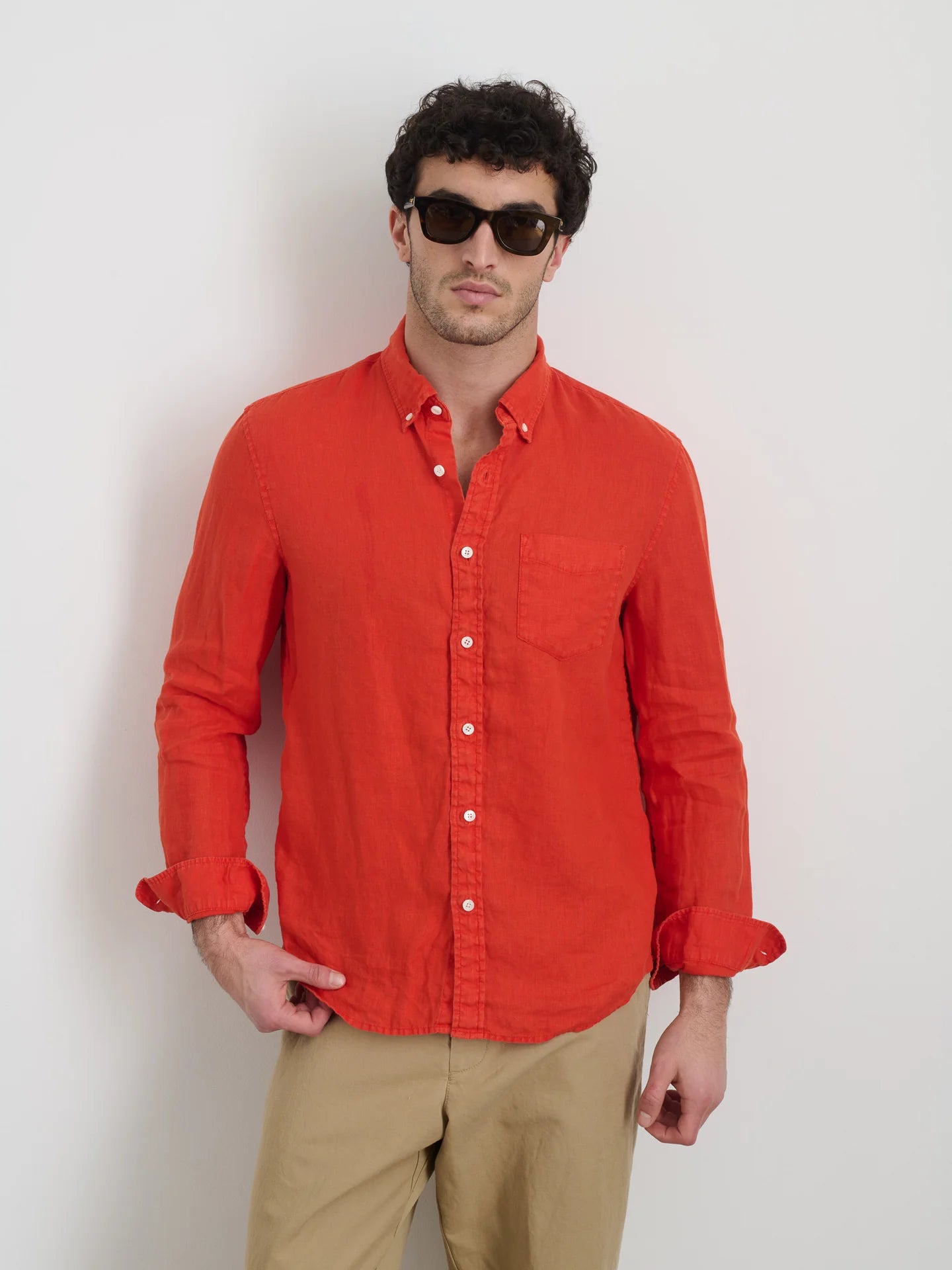 Alex Mill red linen button-down shirt with chest pocket on model wearing sunglasses and khaki pants