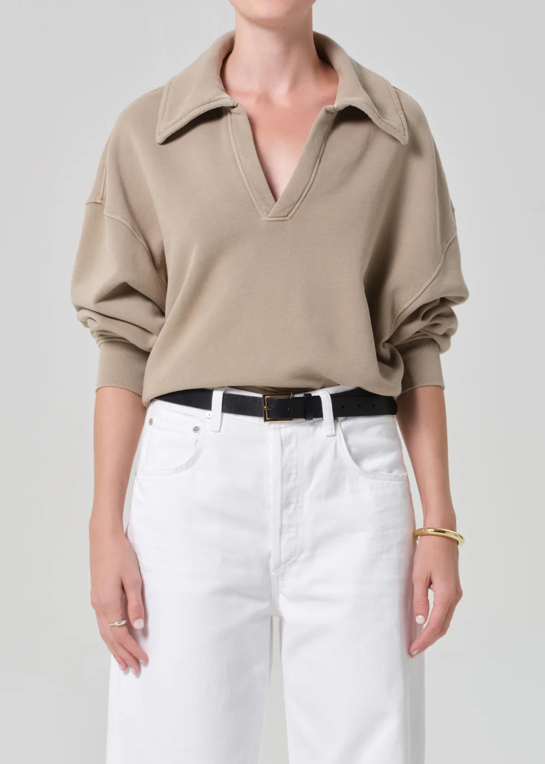 Citizens of Humanity oversized pullover sweatshirt with collar and V-neck, styled with white denim skirt and belt.