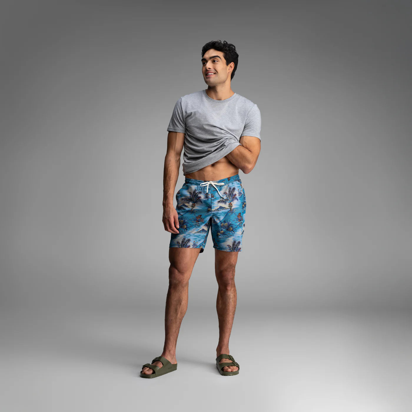 Man wearing BN3TH Shoreline 2-in-1 shorts with tropical palm tree print and drawstring waistband