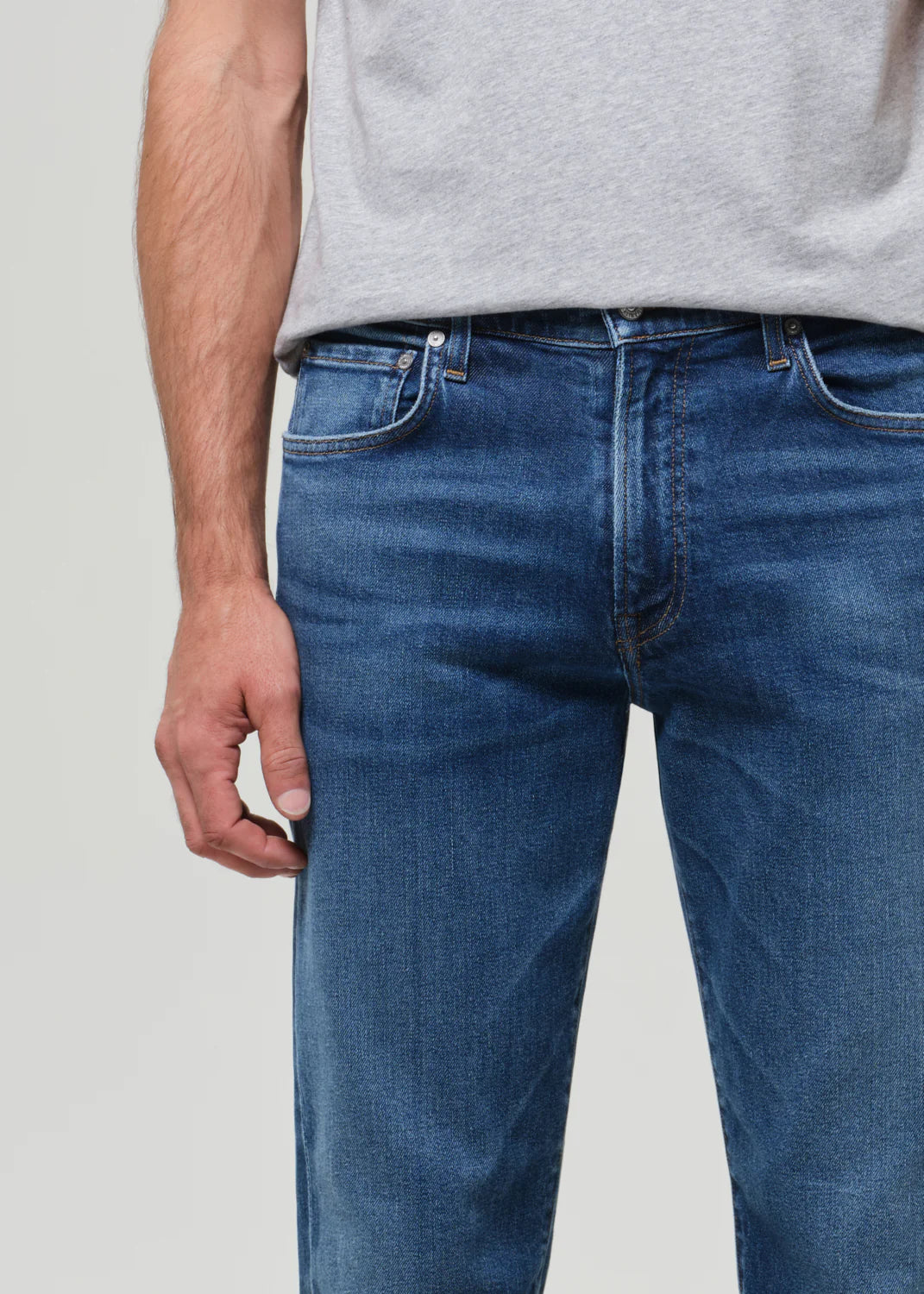 Citizens of Humanity Elijah jeans in medium wash blue denim, styled with a grey t-shirt on male model.