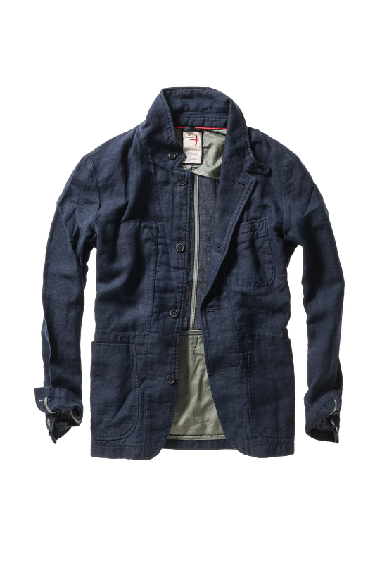 Relwen navy denim blazer with button front closure, multiple pockets, and rolled sleeves worn open over green shirt.