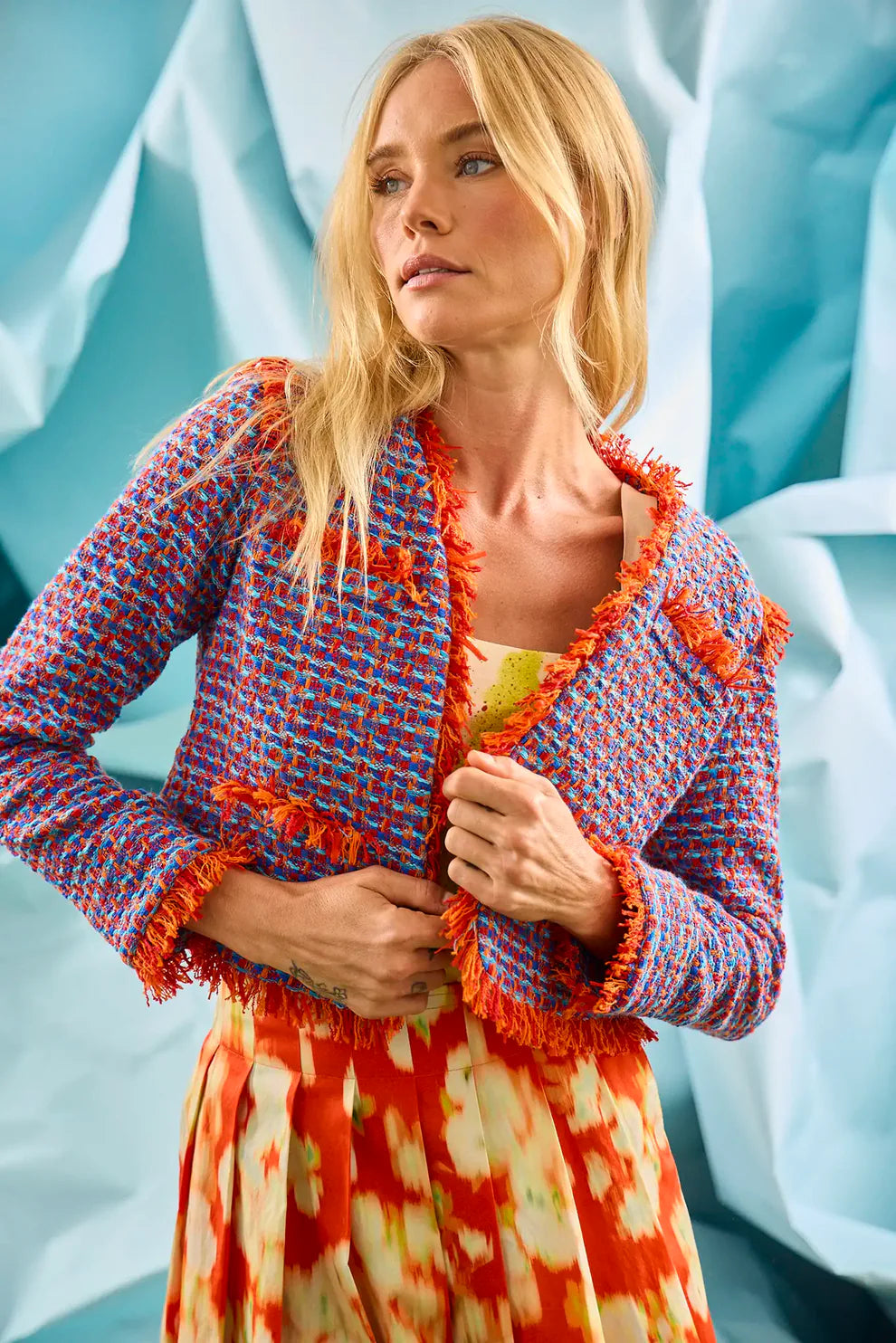 Hunter Bell Coco Jacket in colorful mariner tweed with fringe trim, worn over a patterned dress.