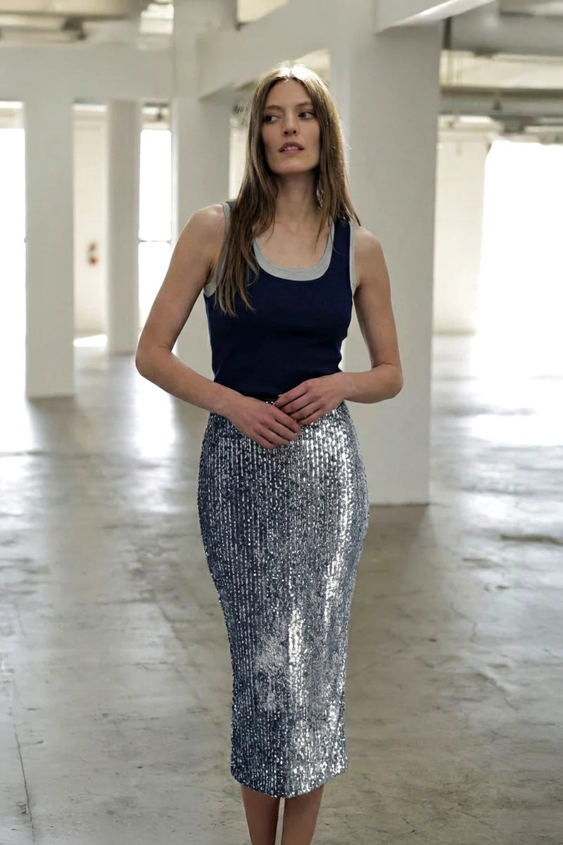Woman wearing Le Superbe Two Timer Tank in navy with heather grey trim, paired with silver sequined midi skirt.