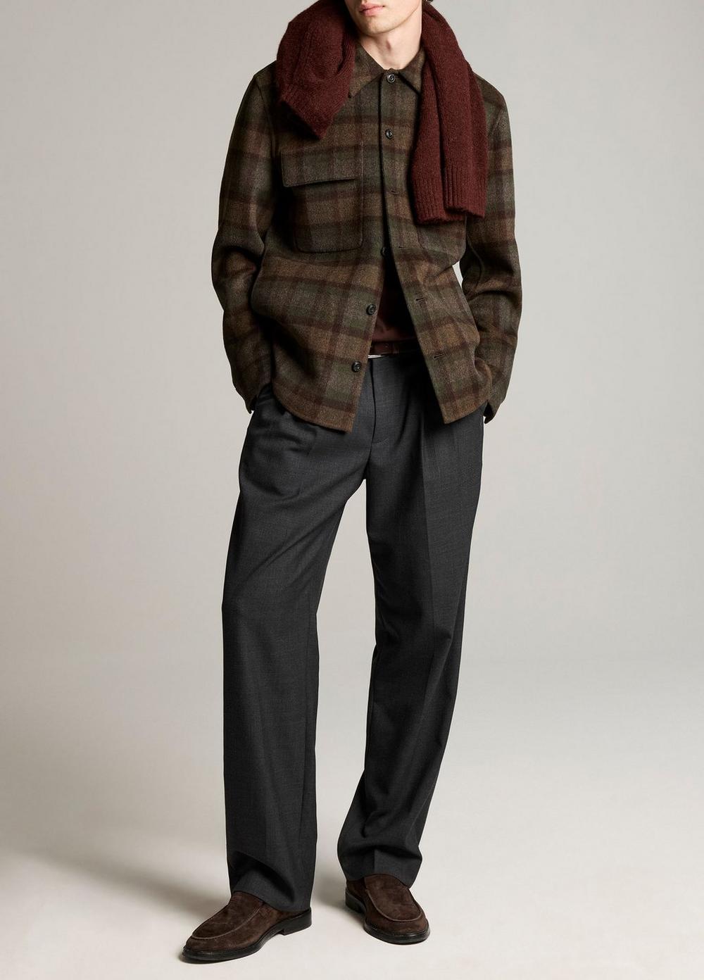 Male model wearing brown-green plaid wool shirt jacket with burgundy scarf and charcoal trousers