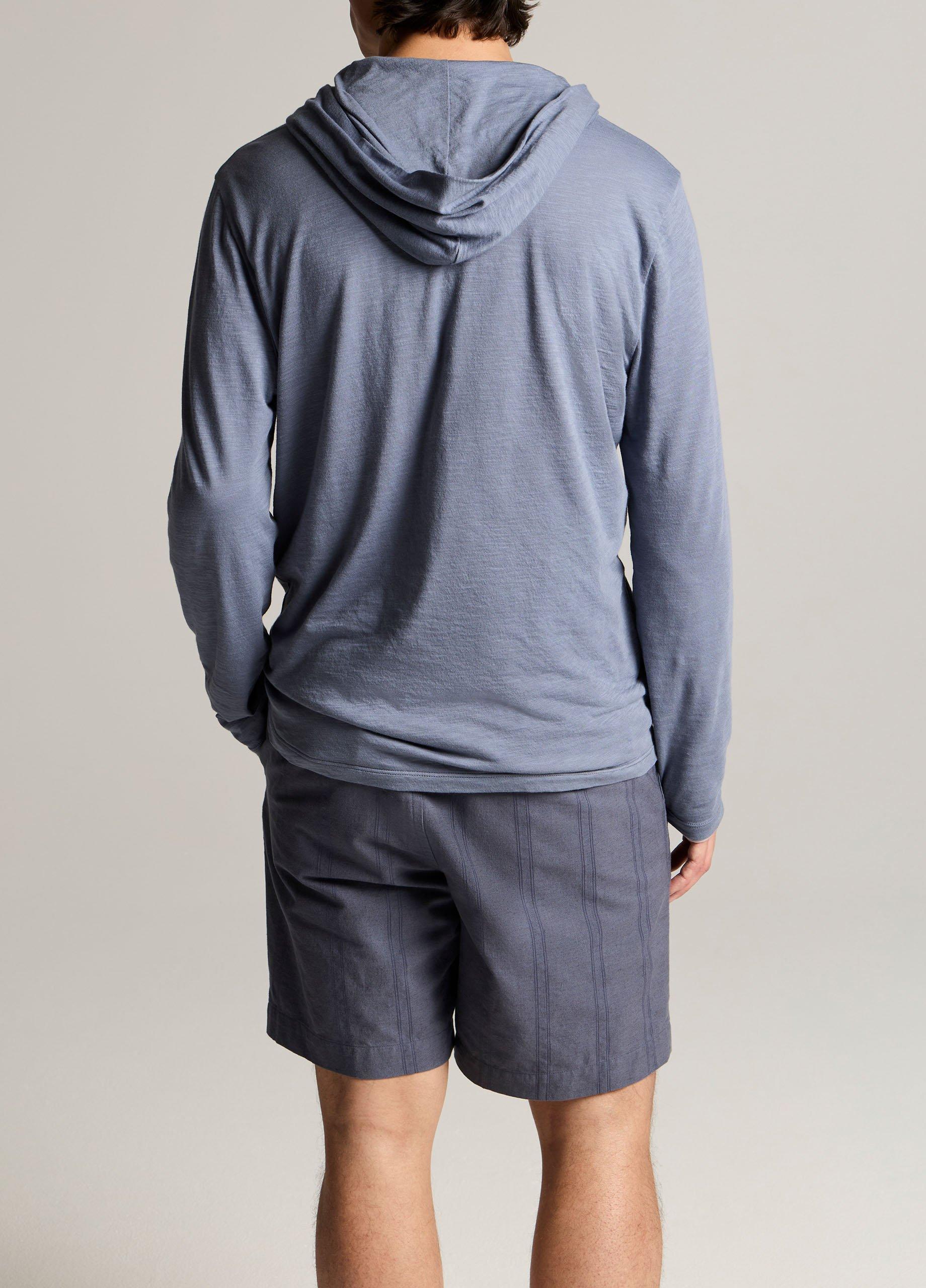 Back view of man wearing slate blue slub pima cotton double-layer hoodie with shorts