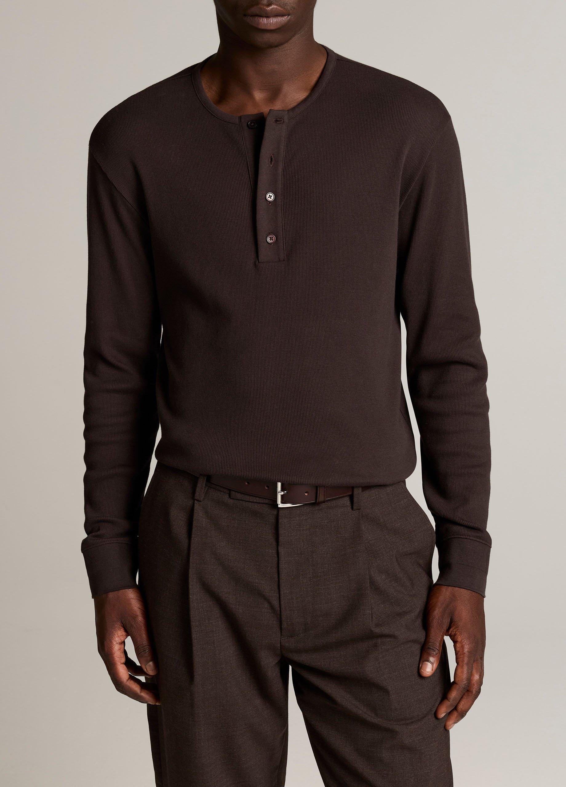 Male model wearing dark brown ribbed cotton long-sleeve henley shirt with button placket