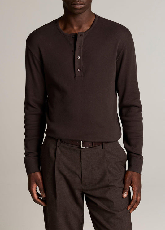 Male model wearing dark brown ribbed cotton long-sleeve henley shirt with button placket