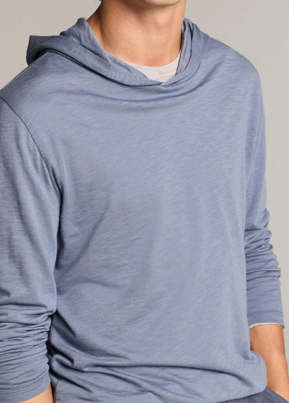 Male model wearing a lightweight blue long-sleeve slub pima cotton hoodie with layered hood